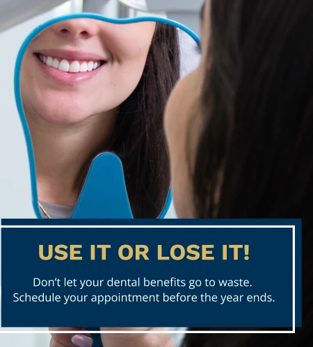 Woman smiling in dental mirror with text reminder to use dental benefits before year ends.
